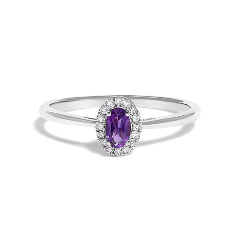 Silver ring with a purple gemstone and diamond accents on a white background